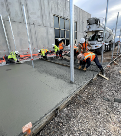 MC Green employees leveling cement, paving